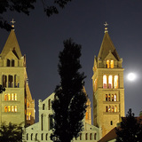 A cathedral with the Moon and Jupiter in the background