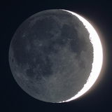 The darker side of the moon by light reflected off Earth