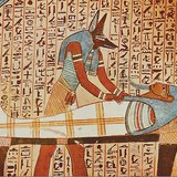 Anubis, the jackal-headed god attends the mummy